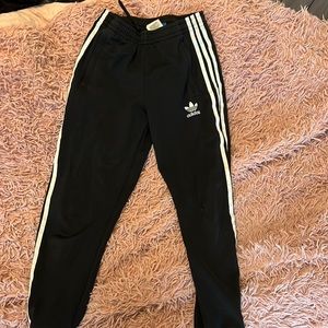 Black and white adidas joggers, worn